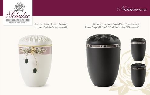 Zwei stilvolle Urnen: Eine cremeweiße Urne mit satiniertem Schmuck und eine anthrazitfarbene Urne im Art-Déco-Stil.