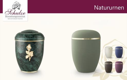 Zwei Urnen in unterschiedlichen Designs: links eine grüne Urne mit goldener Verzierung, rechts eine matte, graue Urne.